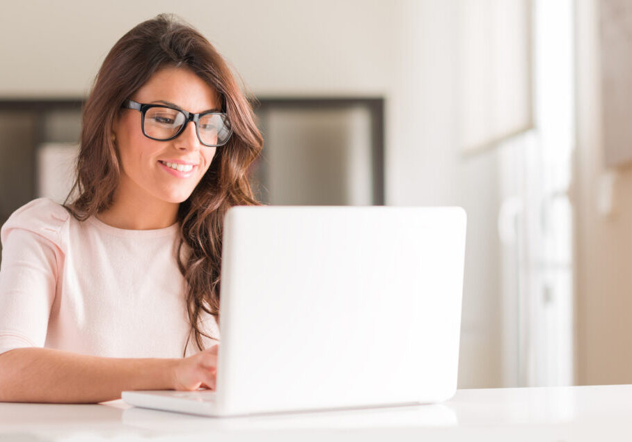 Young Woman Using Laptop Happy Young Beautiful Woman Using Laptop, Indoors